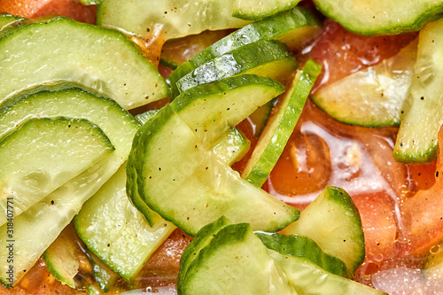 Fresh tomato and cucumber salad close up photo