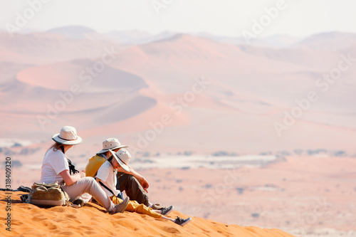 Family on red sand dune