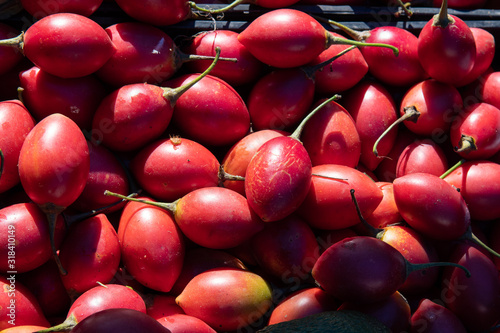 Fresh tamarillo fruit vegetable at market stall at Municipal Market in Armacao de Pera in Portugal.