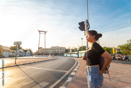 Photography Backpack asian women travel on street of Bangkok city Saochingcha red pole enjoy