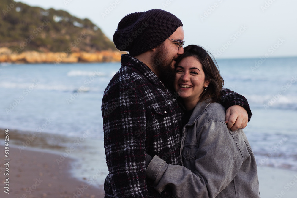 young couple smiling on the beach