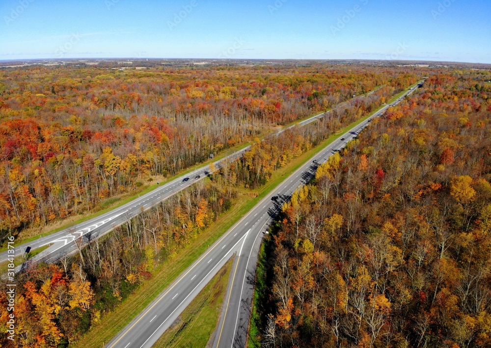 The aerial view of the traffic and stunning fall foliage near Interstate 81 highway of Watertown, New York, U.S.A