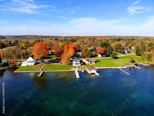 he aerial view of the waterfront residential area surrounded by striking fall foliage by St Lawrence River of Wellesley Island, New York, U.S.A photo