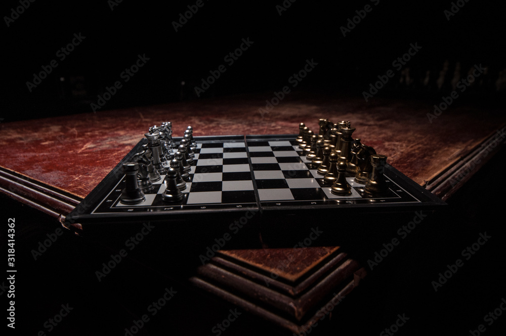 Chess figures on a dark background with smoke and fog. Selective focus Chess figures on a dark background with smoke and fog. Selective focus