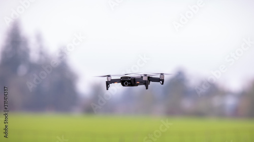 Drone hovering above the ground against blurred background