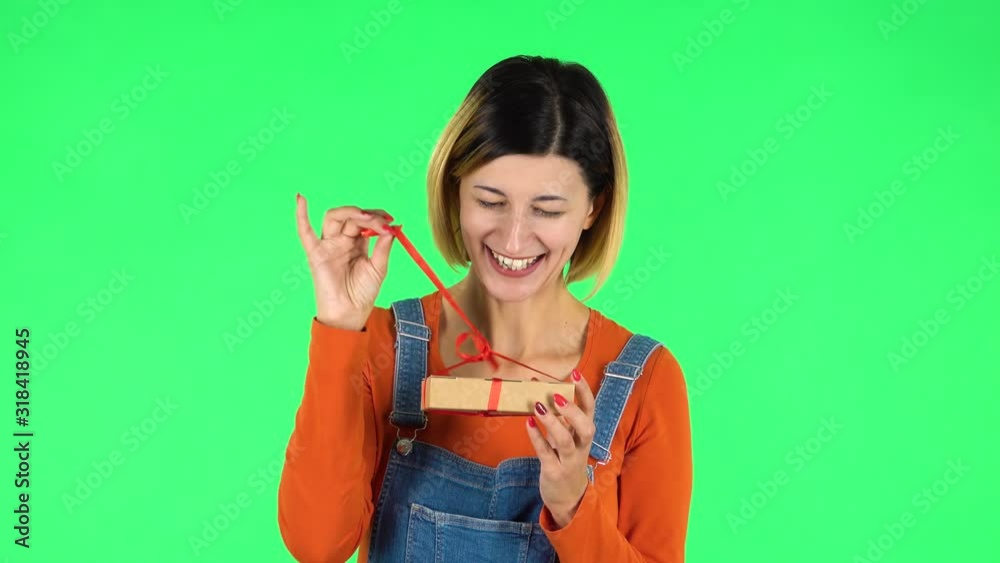Girl opens the gift, surprised and rejoices. Green screen Girl opens the gift, surprised and rejoices. Green screen