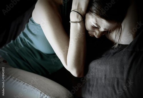 Young woman covering her ears and screaming