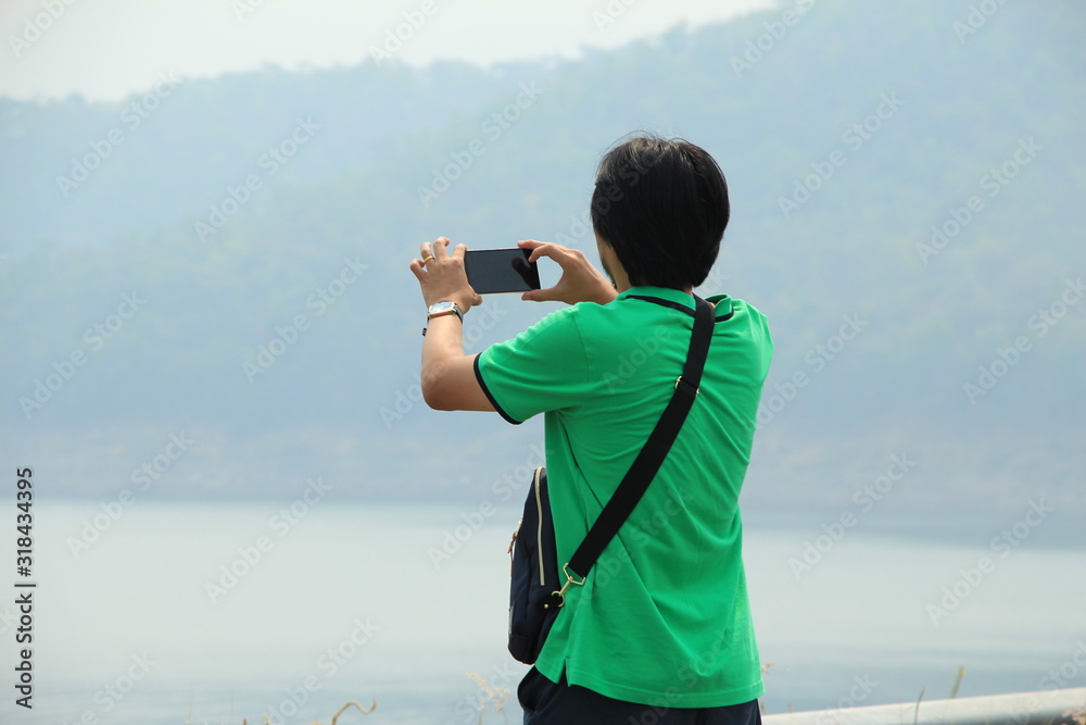 man taking photo with smartphone