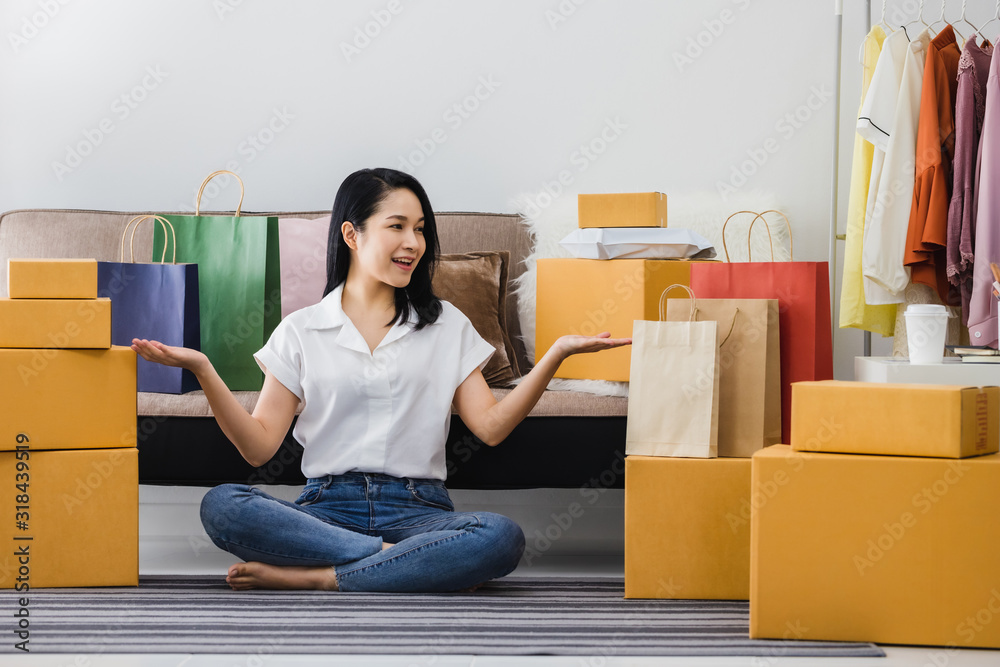 Asian beautiful woman working with online business shop at home.Owner businesswoman start up with Accept orders,Check the number of products, Prepare to deliver products to customers. Asian beautiful woman working with online business shop at home.Owner businesswoman start up with Accept orders,Check the number of products, Prepare to deliver products to customers.