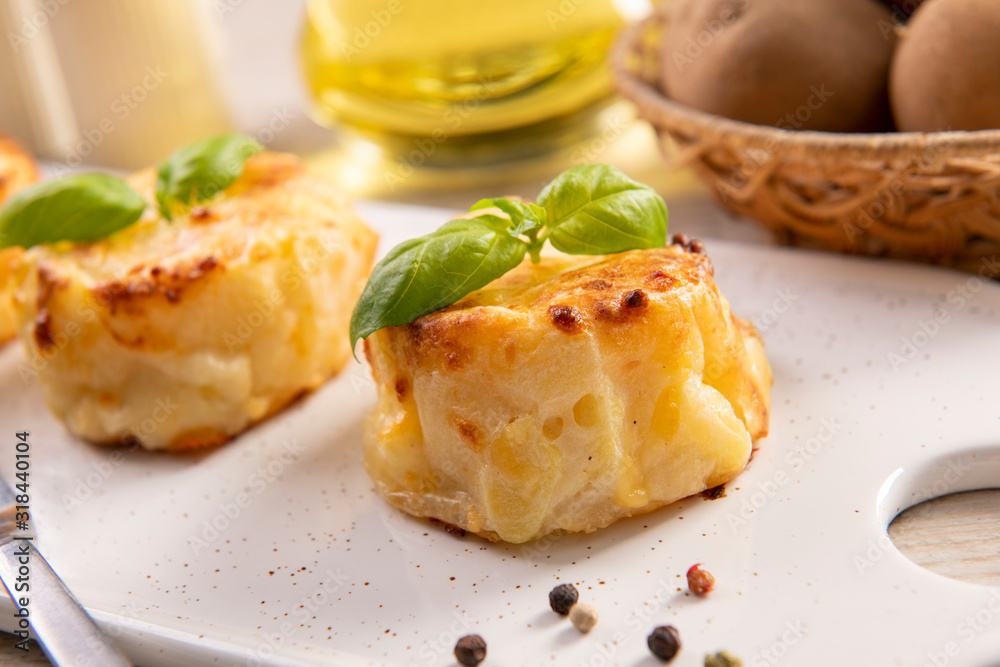 Small casseroles made from potatoes and cheese