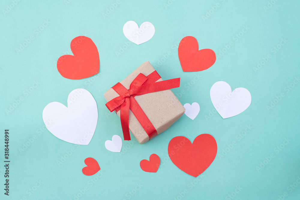 Gift box, red and white hearts on blue pastel background. Valentine's day or wedding ceremony concept and design