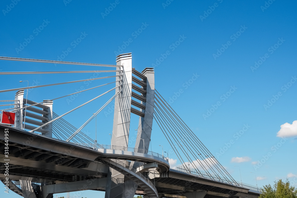 Part of metal bridge construction.Part of the big City Bridge on blue sky background. Copy space. road for transport. Metal Construction. Modern Architecture. Urban style. Part of metal bridge construction.Part of the big City Bridge on blue sky background. Copy space. road for transport. Metal Construction. Modern Architecture. Urban style.