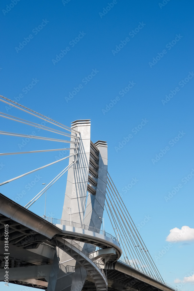 Part of metal bridge construction.Part of the big City Bridge on blue sky background. Copy space. road for transport. Metal Construction. Modern Architecture. Urban style. Part of metal bridge construction.Part of the big City Bridge on blue sky background. Copy space. road for transport. Metal Construction. Modern Architecture. Urban style.