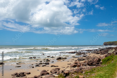 rocks, sand and sea of the city of Torres beach on a blue sky day © Fotos GE