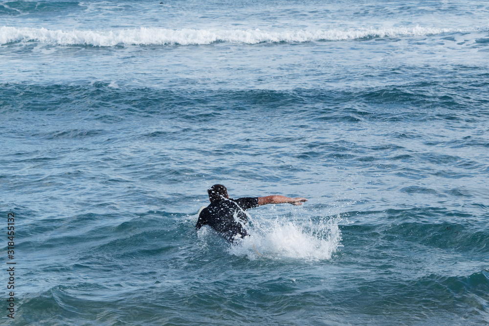 Male swim to line up with surfboard. Vacation concept. Summer holidays. Tourism, sport. Male swim to line up with surfboard. Vacation concept. Summer holidays. Tourism, sport.