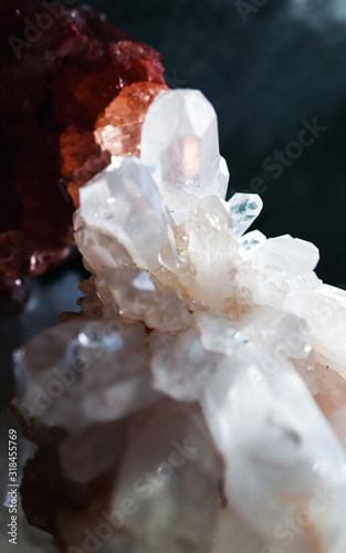 Untouched gemstone cluster clear closeup as a part of geode filled with rock Rose Quartz crystals.