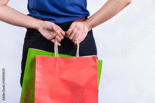Shopping bags with red and green colors A woman's hand On a white background