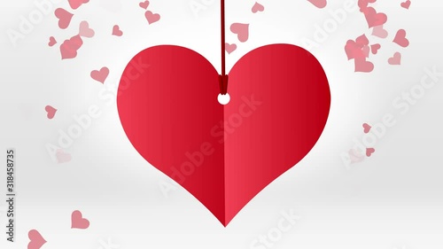 Red paper heart hanging on red string with red hearts particles on white background