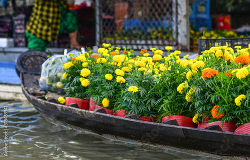 Wooden boat carrying flowers at the market
