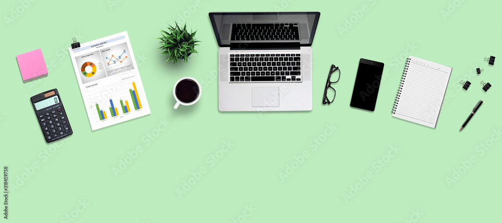 Top view office desk and supplies, with copy space. Creative flat lay photo of workspace desk/Panoramic banner and isolated on green background Top view office desk and supplies, with copy space. Creative flat lay photo of workspace desk/Panoramic banner and isolated on green background