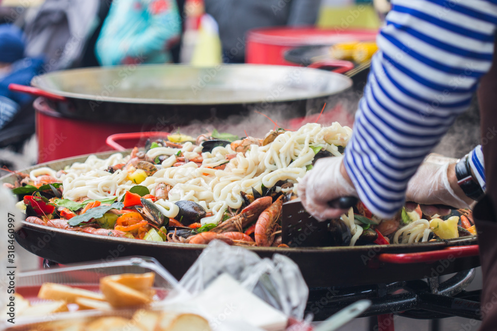 Fototapeta premium Spanish paella prepared in the street restaurant.