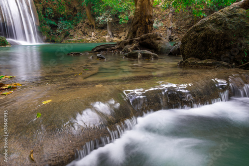 Fototapeta Naklejka Na Ścianę i Meble -  Waterfalls in the emerald blue water in Erawan National Park.beautiful natural rock waterfall in Kanchanaburi, Thailand.Onsen atmosphere.