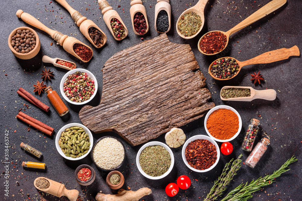 Spices and herbs over black stone background. Top view with free space for menu or recipes Spices and herbs over black stone background. Top view with free space for menu or recipes