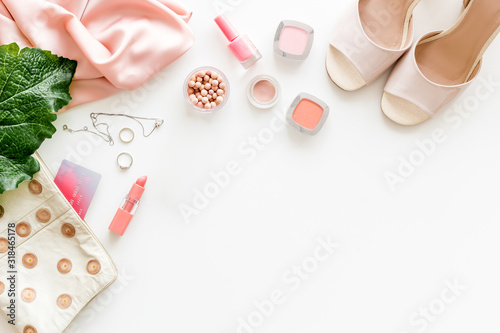 Female outfit. Clothes, shoes, cosmetics on white background top-down frame copy space