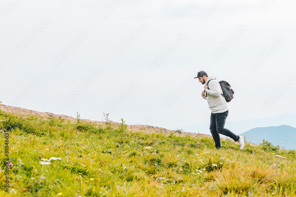 man with backpack hiking in mountains man with backpack hiking in mountains