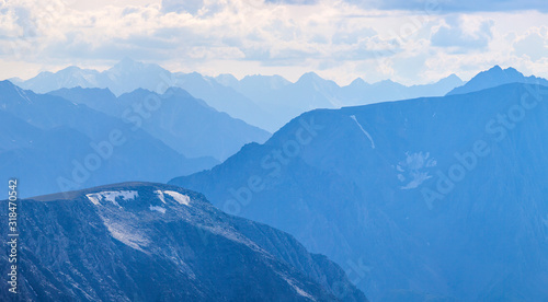 Mountain peaks in blue haze. Traveling in the mountains, trekking.