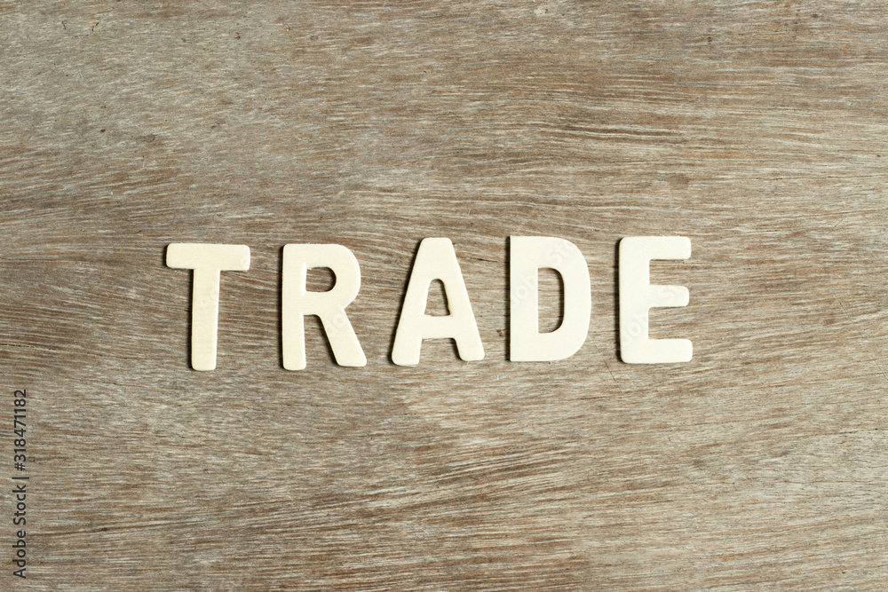 Alphabet letter in word trade on wood background Alphabet letter in word trade on wood background