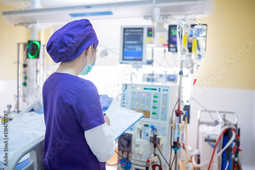 The specialist are checking continuous renal replacement therapy equipment and injection pump and hemodialysis machine.