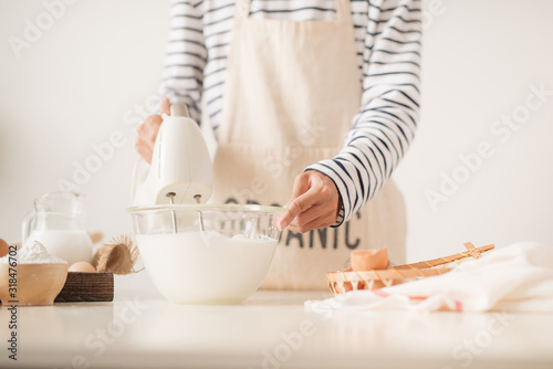 Obraz na plátne Kitchen mixer whipped cream custard pastry whisk rotates rapidly