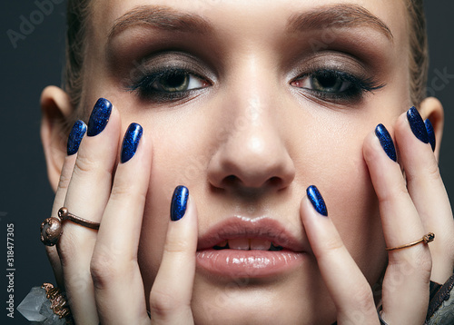 Young woman with many bijouterie rings with stones on fingers