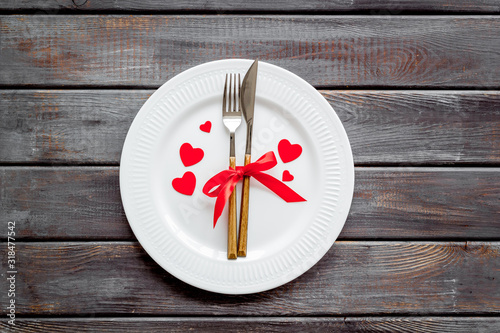 Valentines day table. Plate on dark wooden background top-down copy space