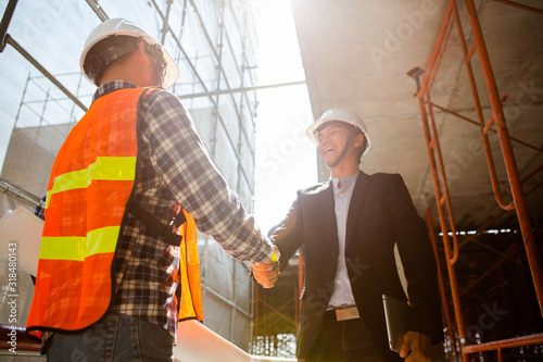Engineers oversaw the construction site skyscraper.