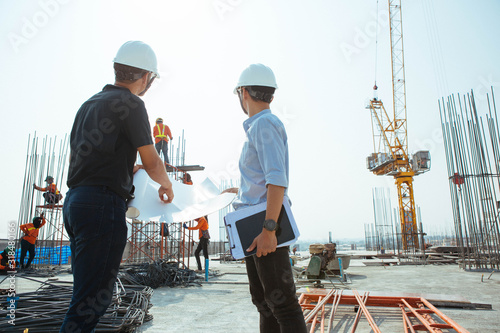 Engineers oversaw the construction site skyscraper.