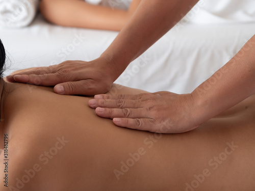 Asian woman are a relaxing on bed. backs massage in the Spa Salon. Thai massage for health.