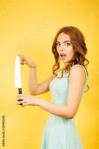 girl with kitchen knife checks the sharpness