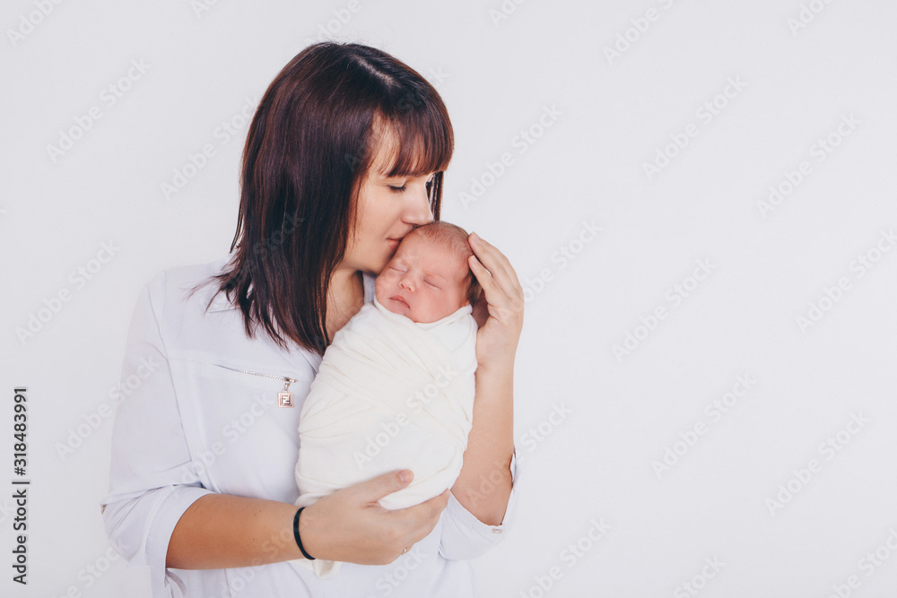 the concept of a healthy lifestyle, the protection of children, shopping - baby in the arms of the mother. Woman holding a child. Isolated on white background. Copy space the concept of a healthy lifestyle, the protection of children, shopping - baby in the arms of the mother. Woman holding a child. Isolated on white background. Copy space
