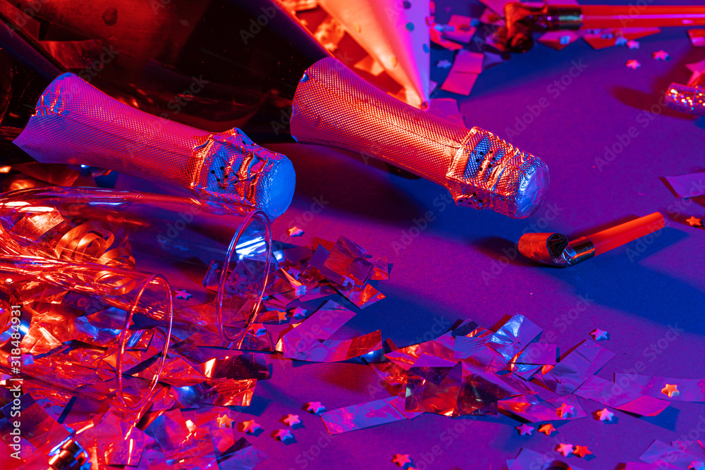 Champagne bottle on a purple background close up. Party concept Champagne bottle on a purple background close up. Party concept