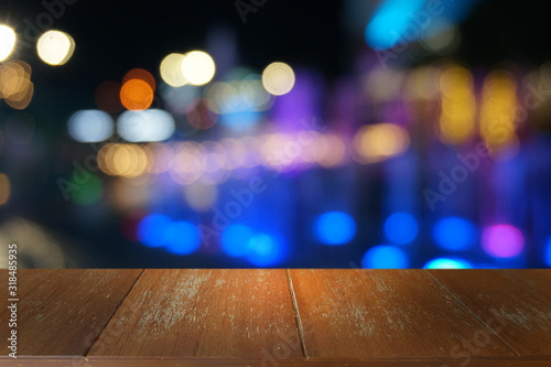 Empty dark wooden table in front of abstract blurred bokeh background of restaurant . can be used for display or montage your products.Mock up for space.