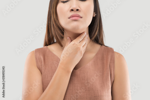 Obraz na plátně Asian women have symptoms of burning sensation on a gray background