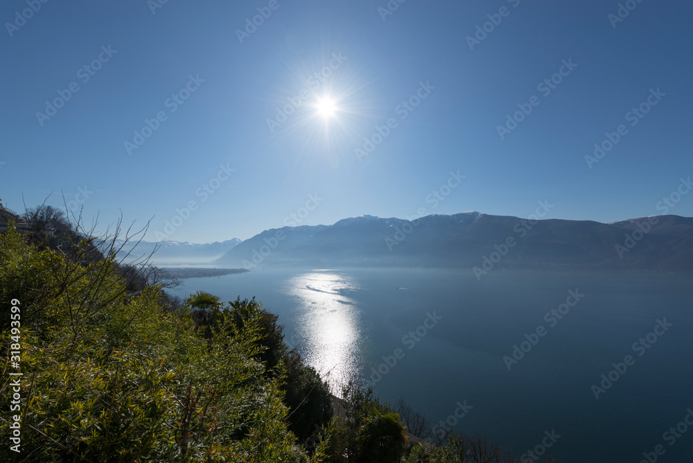 Alpine Lake with Mountain and Sunshine in Ticino, Switzerland.