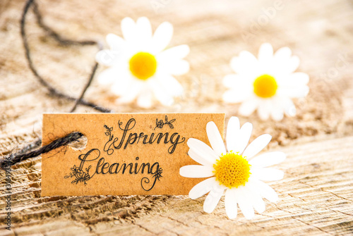 One Label With English Calligraphy Spring Cleaning. Daisy Blossom On Wooden Background