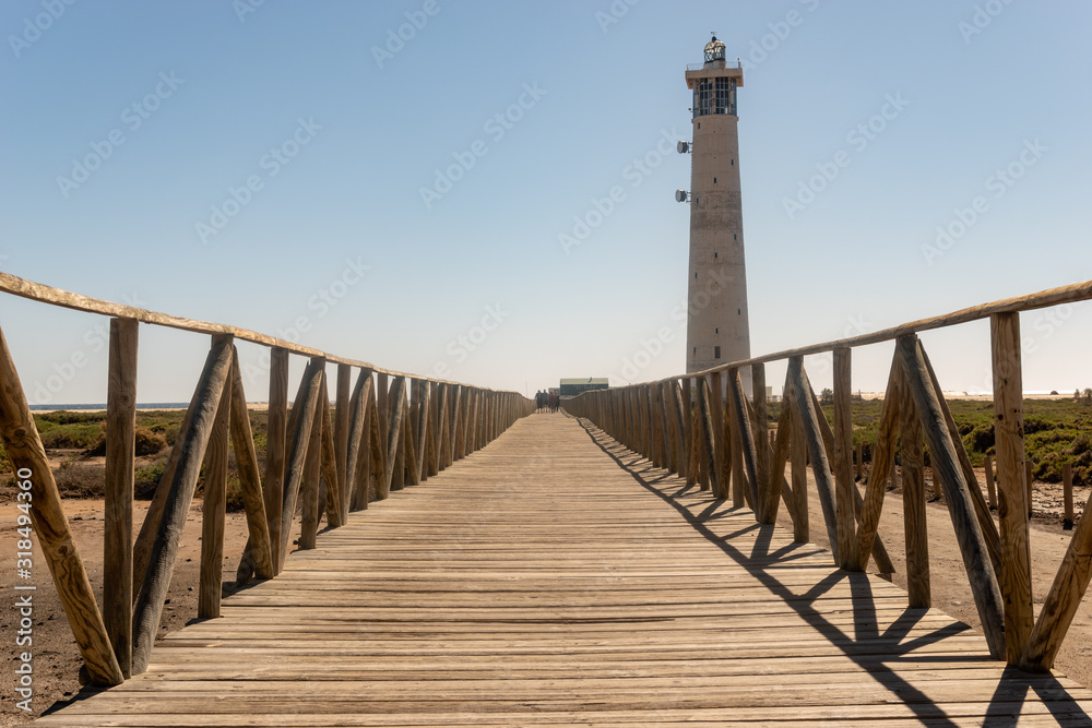 wooden jetty to the ocean and lighthouse, Morro Jable Beach - Fuerteventura wooden jetty to the ocean and lighthouse, Morro Jable Beach - Fuerteventura