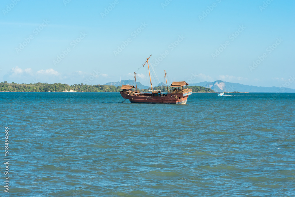 Chinese sailing ship, a junk, moored close to the small town Ban Ko Lanta serves as tourist attraction on the east side of the island of Ko Lanta