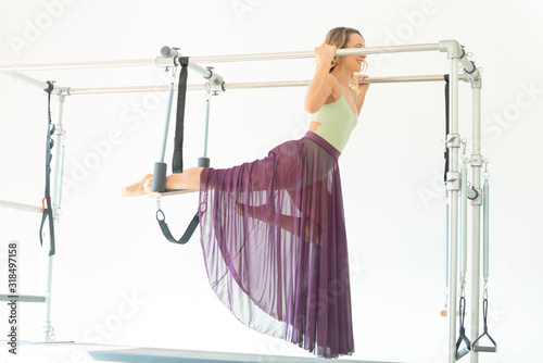 Woman Exercising on Pilates Machine with Transparent Skirt.