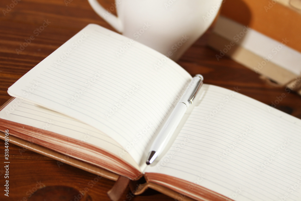 Brown notebook on a wooden table