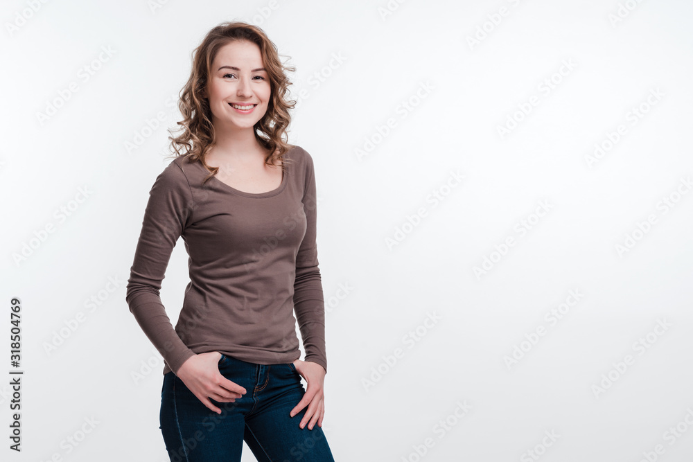 Beautiful model in brown shawl posing on white wall background. Place for advertising, copy space Beautiful model in brown shawl posing on white wall background. Place for advertising, copy space